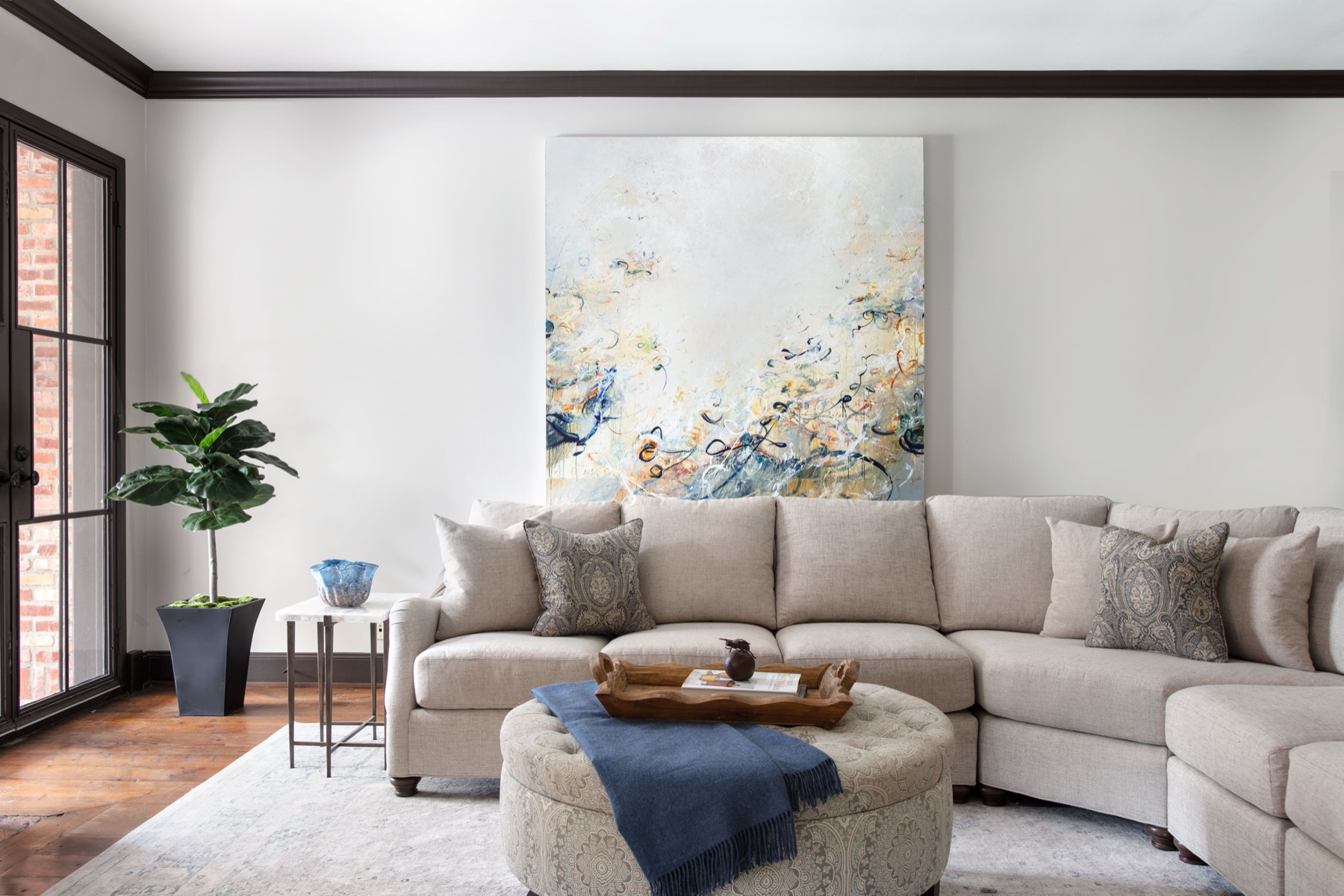Pamela Hope Designs living room with original artwork above the sofa